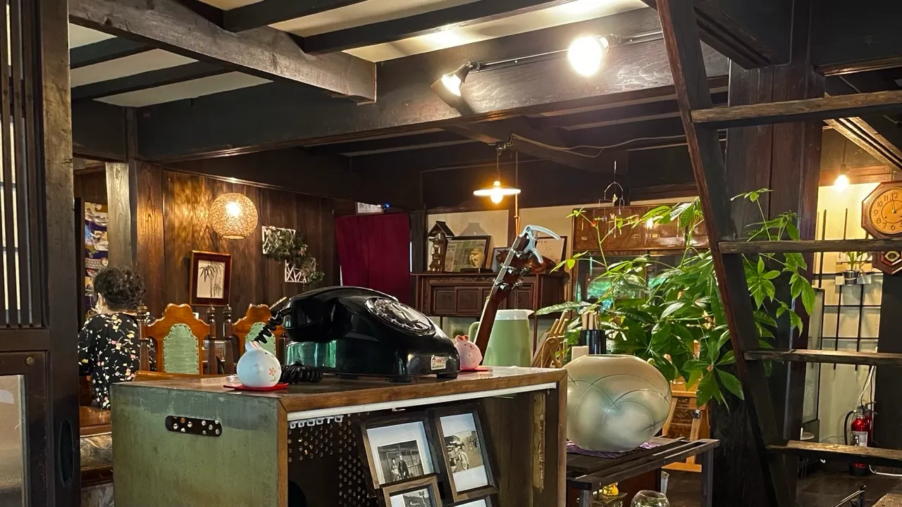 黒電話やアンティークな花瓶が並ぶ、古民家カフェ雅の店内
